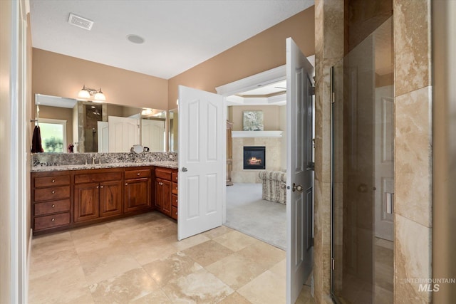 8585 W Rioja St, Star, ID 83669 - bathroom with vanity, a shower stall, and a fireplace