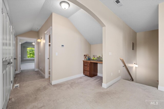 8585 W Rioja St, Star, ID 83669 - bonus room featuring vaulted ceiling, carpet, arched walkways, a textured ceiling, and baseboards