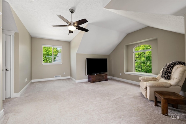 8585 W Rioja St, Star, ID 83669 - living area featuring vaulted ceiling, a textured ceiling, plenty of natural light, a ceiling fan, and carpet floors