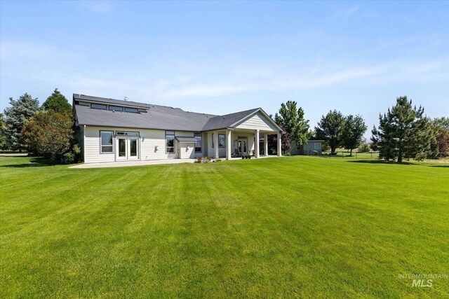 8585 W Rioja St, Star, ID 83669 - rear view of house featuring a patio, a lawn, and french doors