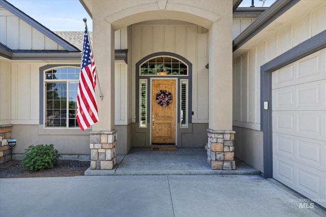 8585 W Rioja St, Star, ID 83669 - view of exterior entry with board and batten siding, a garage, and driveway