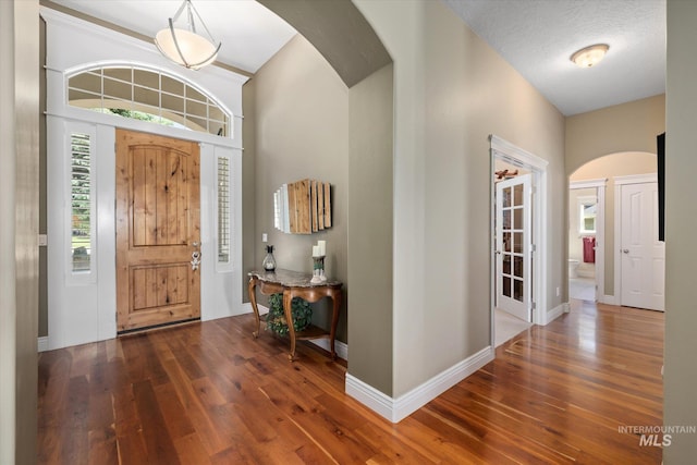 8585 W Rioja St, Star, ID 83669 - foyer featuring arched walkways, hardwood / wood-style floors, and baseboards