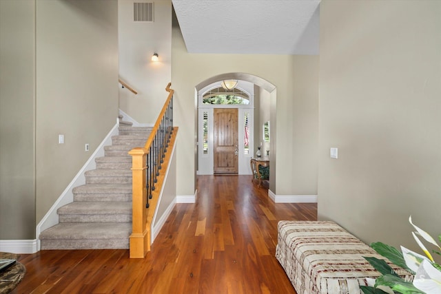 8585 W Rioja St, Star, ID 83669 - foyer with wood finished floors, arched walkways, stairway, and baseboards