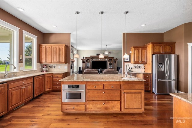 8585 W Rioja St, Star, ID 83669 - kitchen featuring stainless steel appliances, a sink, dark wood-type flooring, and recessed lighting