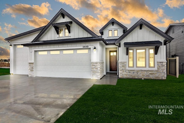 view of front of property featuring a front lawn, board and batten siding, concrete driveway, and an attached garage