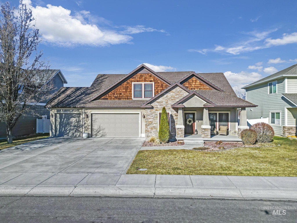 2821 Sundance Dr, Twin Falls, ID 83301 - craftsman inspired home with covered porch, a front lawn, and a garage