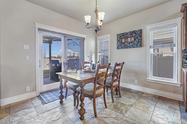 dining area featuring an inviting chandelier