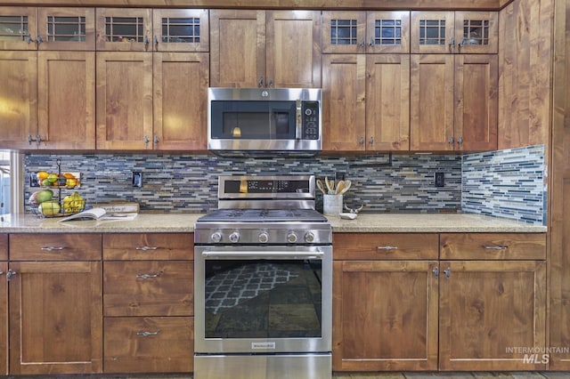 kitchen with stainless steel appliances and tasteful backsplash