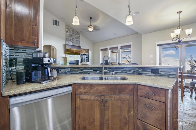 kitchen featuring vaulted ceiling, dishwasher, tasteful backsplash, ceiling fan with notable chandelier, and sink