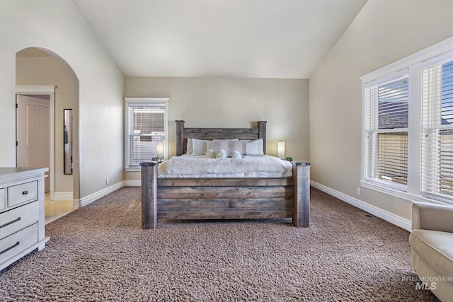 carpeted bedroom with vaulted ceiling