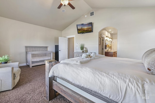 bedroom featuring ceiling fan, connected bathroom, vaulted ceiling, and carpet flooring