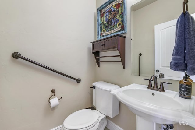 bathroom featuring sink and toilet