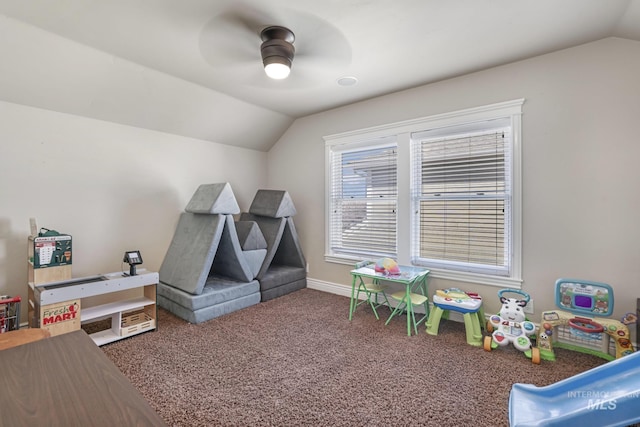 recreation room with ceiling fan, vaulted ceiling, and dark carpet