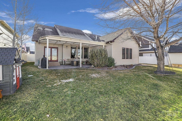 rear view of property with a pergola, a patio, a storage shed, and a lawn