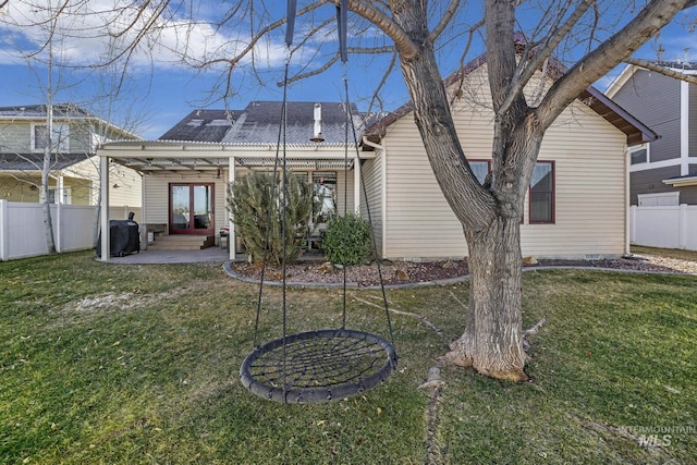 rear view of property with a lawn, a patio area, and a pergola