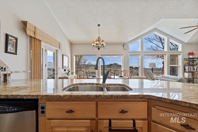 kitchen featuring a sink, stainless steel dishwasher, a textured ceiling, light stone countertops, and vaulted ceiling