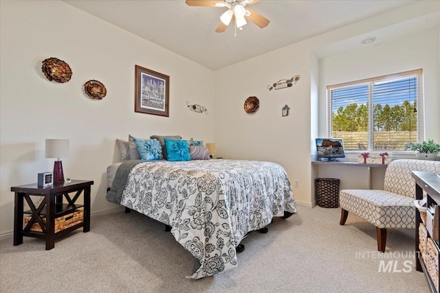 bedroom with a ceiling fan, baseboards, and light carpet