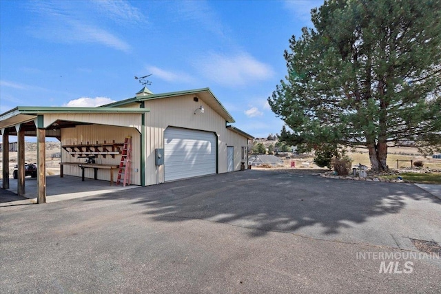 view of home's exterior featuring a detached garage