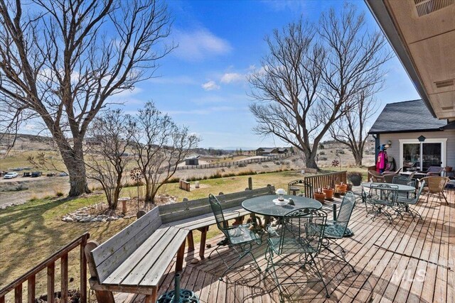 deck with a yard, outdoor dining space, and a patio area