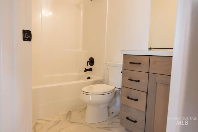 bathroom featuring toilet, marble finish floor, and washtub / shower combination