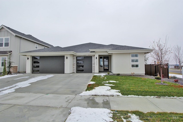 prairie-style house with a front lawn and a garage