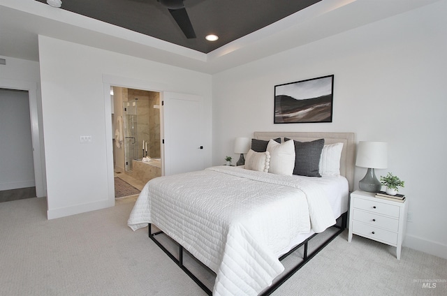 carpeted bedroom with ceiling fan and ensuite bath