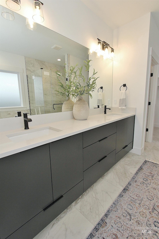 bathroom featuring a shower with shower door and vanity