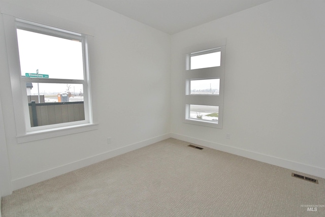 unfurnished room with light colored carpet