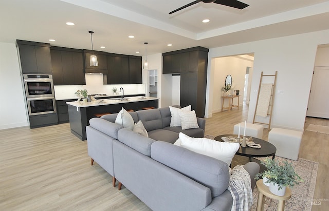 living room featuring light hardwood / wood-style floors and ceiling fan