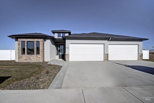5728 S Keyport Way, Meridian, ID 83642 - prairie-style home with stone siding, driveway, a garage, and stucco siding