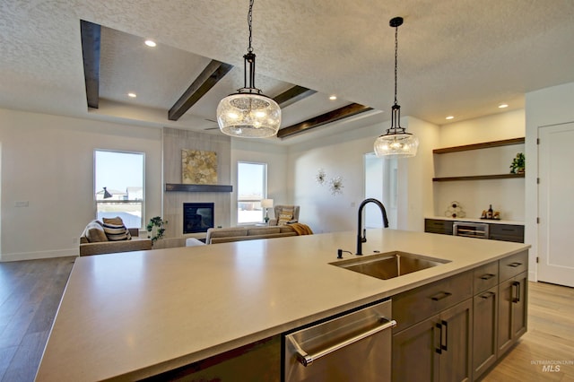 5728 S Keyport Way, Meridian, ID 83642 - kitchen featuring a sink, open shelves, dishwasher, light wood-style floors, and a textured ceiling