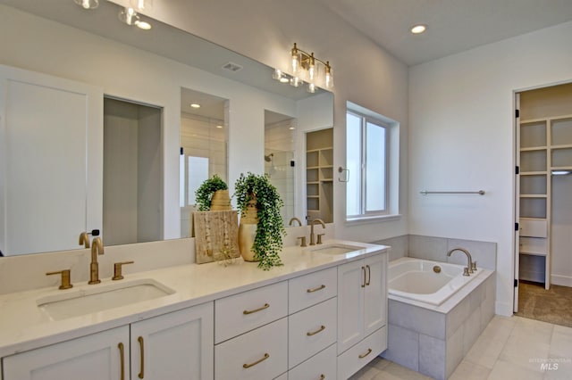 5728 S Keyport Way, Meridian, ID 83642 - full bath featuring double vanity, a bath, a walk in closet, tiled shower, and recessed lighting