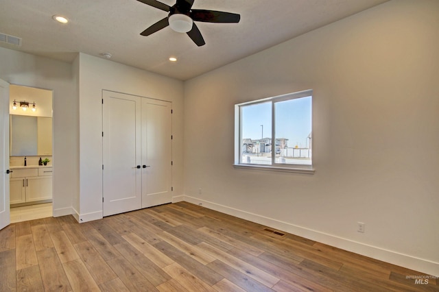 5728 S Keyport Way, Meridian, ID 83642 - unfurnished bedroom featuring baseboards, light wood-style flooring, ensuite bathroom, recessed lighting, and a closet