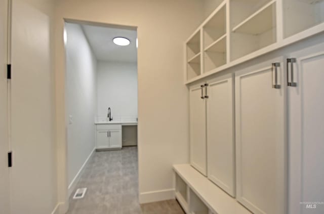 5728 S Keyport Way, Meridian, ID 83642 - mudroom with baseboards and a sink