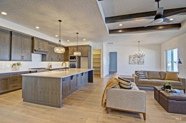 5728 S Keyport Way, Meridian, ID 83642 - kitchen with a sink, open floor plan, a chandelier, light countertops, and oven