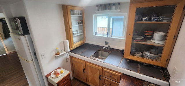 159 Chief Looking Glass Ln, Kamiah, ID 83536 - kitchen with a sink, brown cabinets, dark wood-style flooring, and baseboards