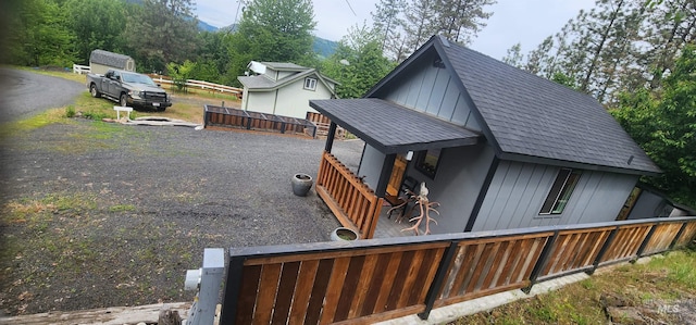 159 Chief Looking Glass Ln, Kamiah, ID 83536 - back of house with a shingled roof, board and batten siding, fence, and driveway