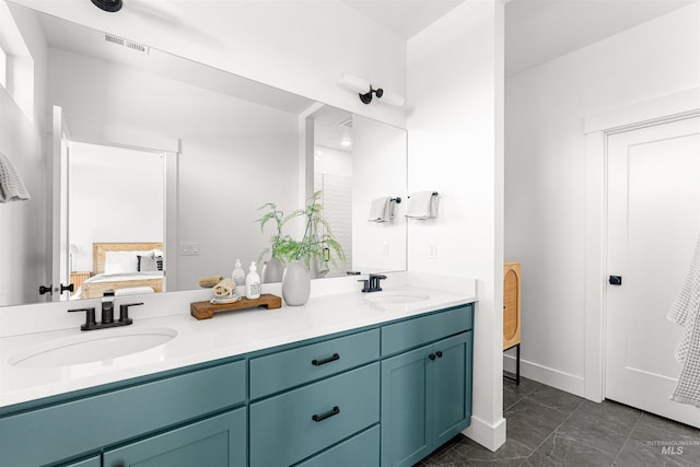 357 E Lombard Ln The Dayton, Unit The Dayton, Eagle, ID 83616 - ensuite bathroom featuring double vanity, marble look tile flooring, and baseboards
