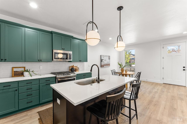 357 E Lombard Ln The Dayton, Unit The Dayton, Eagle, ID 83616 - kitchen with stainless steel appliances, a sink, backsplash, light countertops, and recessed lighting