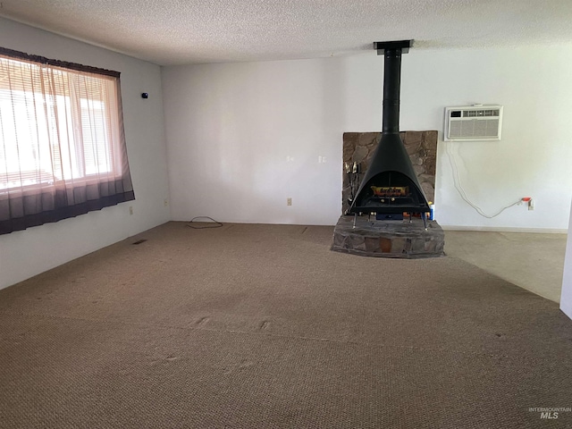 1472 En Casa Villa Dr, Mountain Home, ID 83647 - unfurnished living room with a wall unit AC, carpet floors, a wood stove, and a textured ceiling