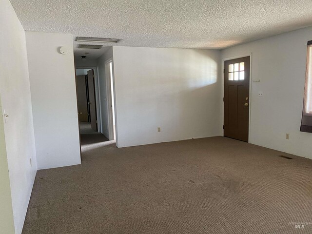 1472 En Casa Villa Dr, Mountain Home, ID 83647 - unfurnished room featuring carpet floors, a textured ceiling, and a smoke detector