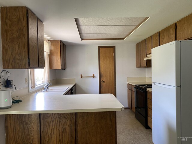 1472 En Casa Villa Dr, Mountain Home, ID 83647 - kitchen with freestanding refrigerator, electric range, a sink, light countertops, and a peninsula