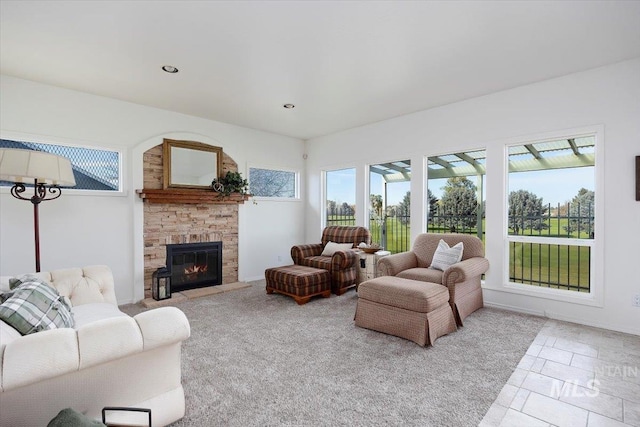 living room featuring a stone fireplace