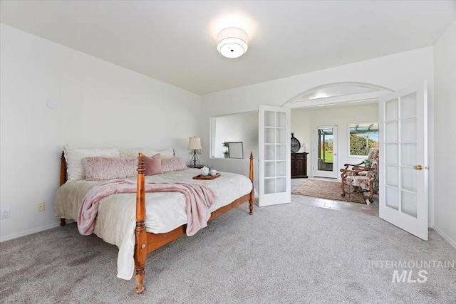 carpeted bedroom featuring french doors