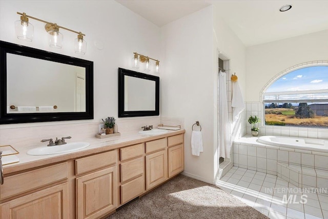 bathroom featuring vanity, tile patterned flooring, and separate shower and tub