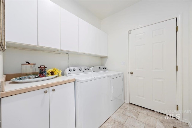 laundry room featuring cabinets and washing machine and clothes dryer