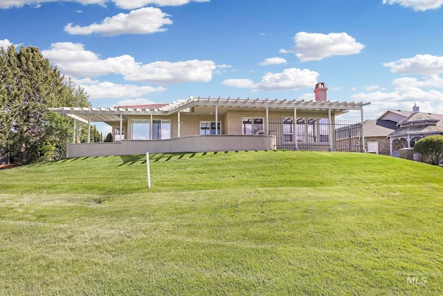 rear view of house with a yard