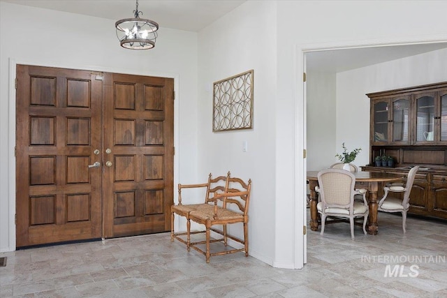 foyer entrance featuring an inviting chandelier