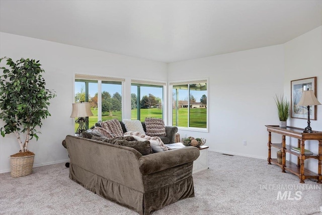 living room with plenty of natural light and light colored carpet