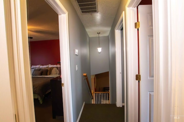 hallway with a textured ceiling